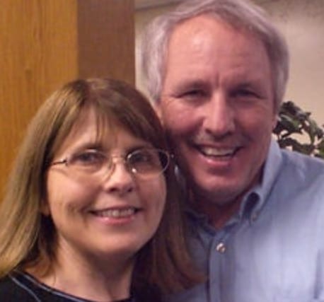 Eric Flowers, smiling, with his wife